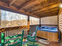 Hot tub and rocking chairs on the deck outside of the master bedroom